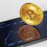 Golden bitcoin on smartphone screen