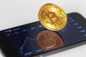 Golden bitcoin on smartphone screen