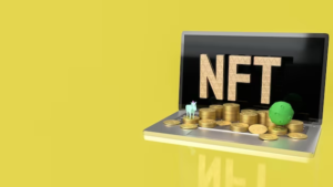 Coins on laptop keyboard with 'NFT' displayed on the screen