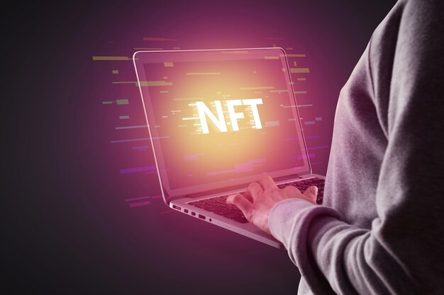 Person on a laptop with an NFT coin on the screen