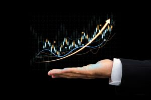 A hand presenting a rising trend line on a digital stock chart